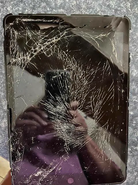 An iPad with a badly shattered screen